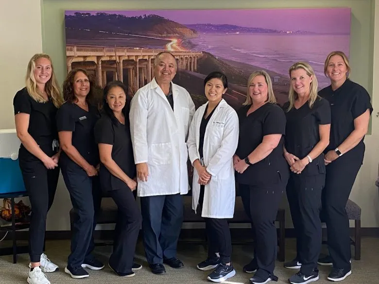 Dr. Chan and staff gathered for a team photo in front of a clinic